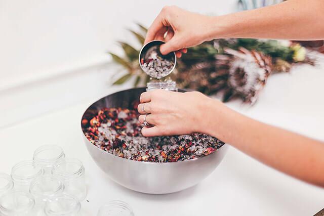 Among The Flowers beauty products being scooped into packaging