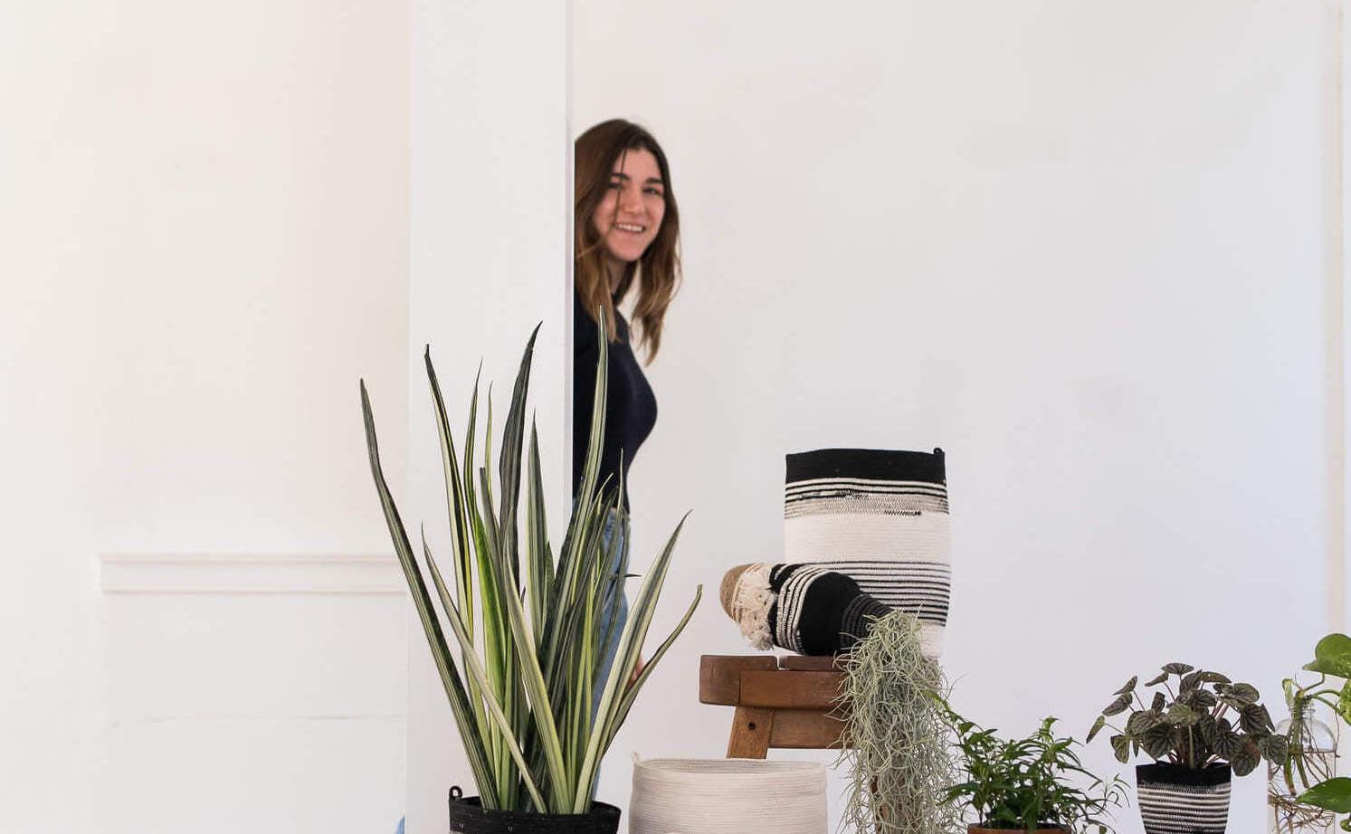 Moriah Okun featured with a spread of her handwoven planters