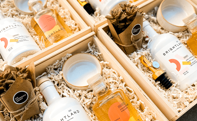 Several gift boxes filled with live plants and custom branded elements for employee gifting