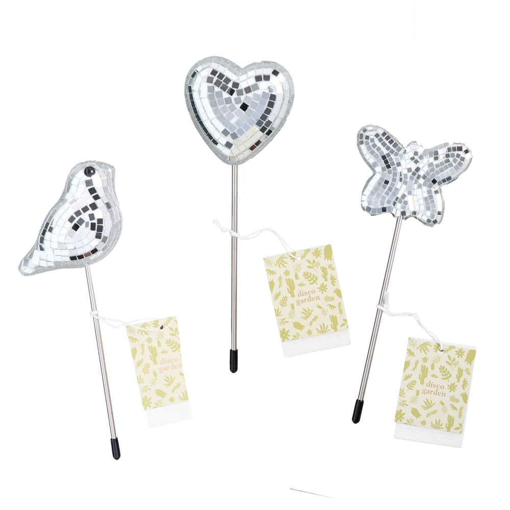 Three mirror disco ball decorative plant accessories shaped like a bird, butterfly and a heart with branded plantable hangtags on plain white background