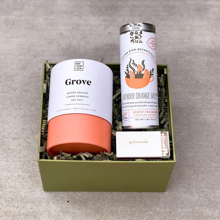 Congrats gift box with orange candle, tea and matches