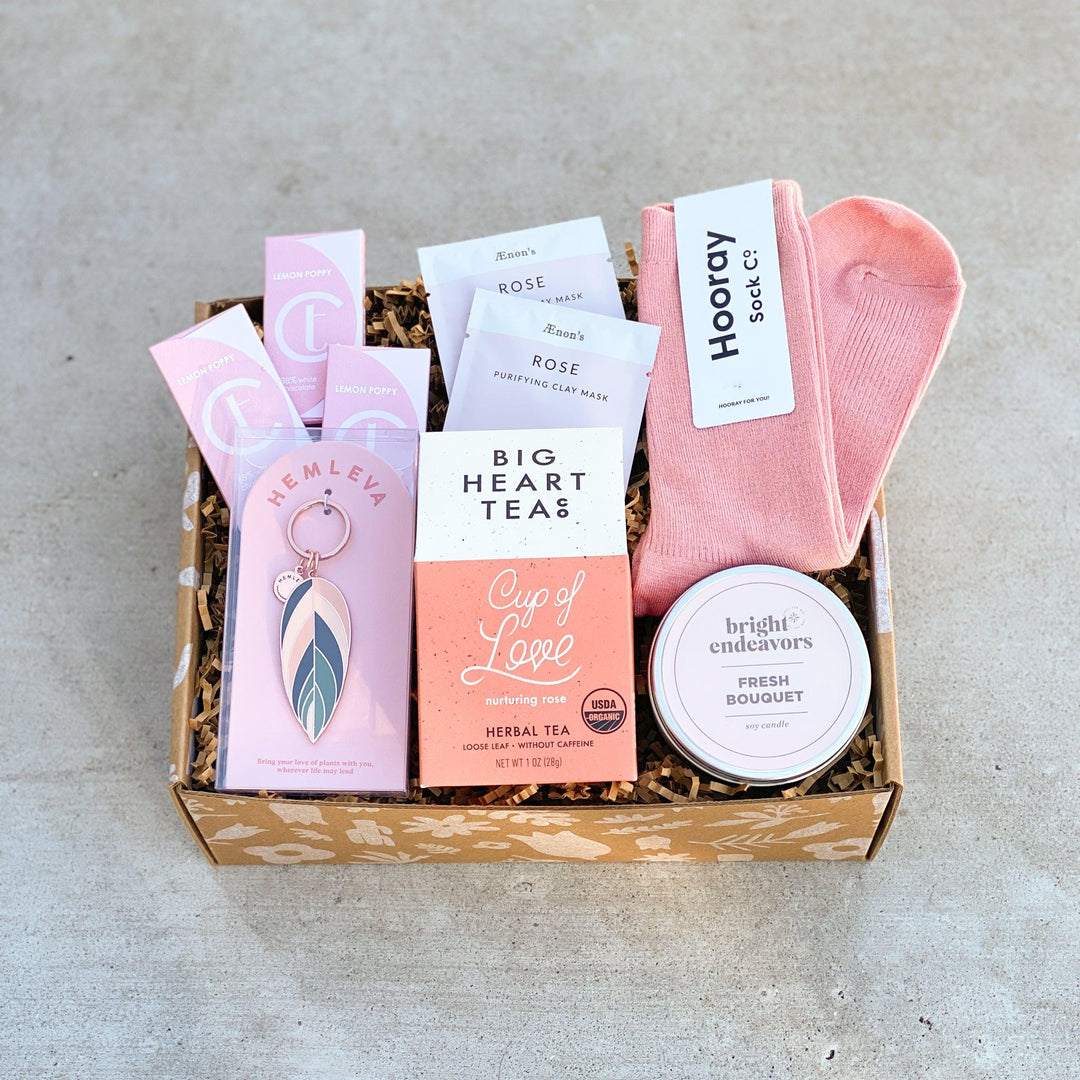 Rose themed gift box with blush colored gifts for birthday