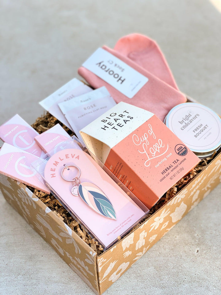 Rose themed gift box with blush colored gifts for her